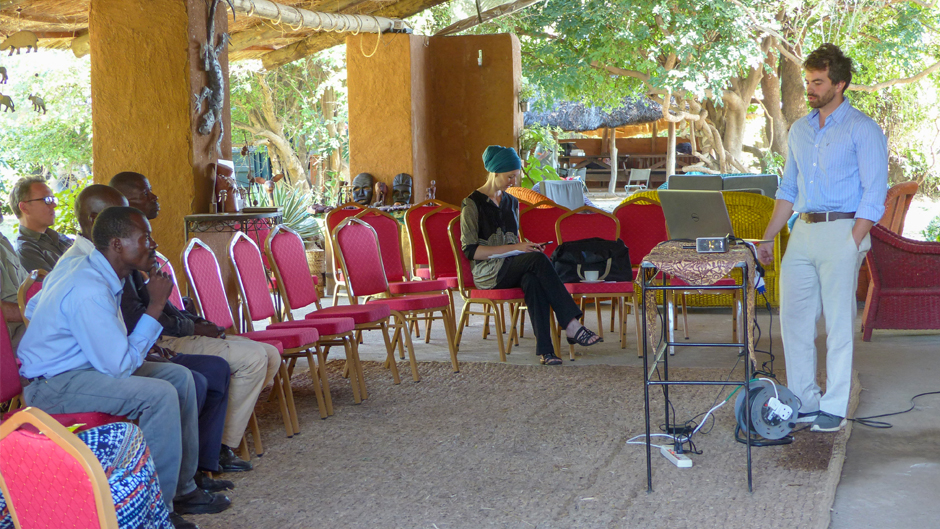 Speaking to a group of residents, environmentalists, and other stakeholders in Zambia, Julius Dewald delivers a presentation on conservation issues in South Luangwa National Park and surrounding areas. (University of Miami)