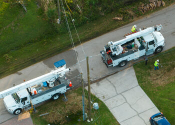 An aerial view of utility workers repairing power lines after Hurricane Ian (iStock image)
