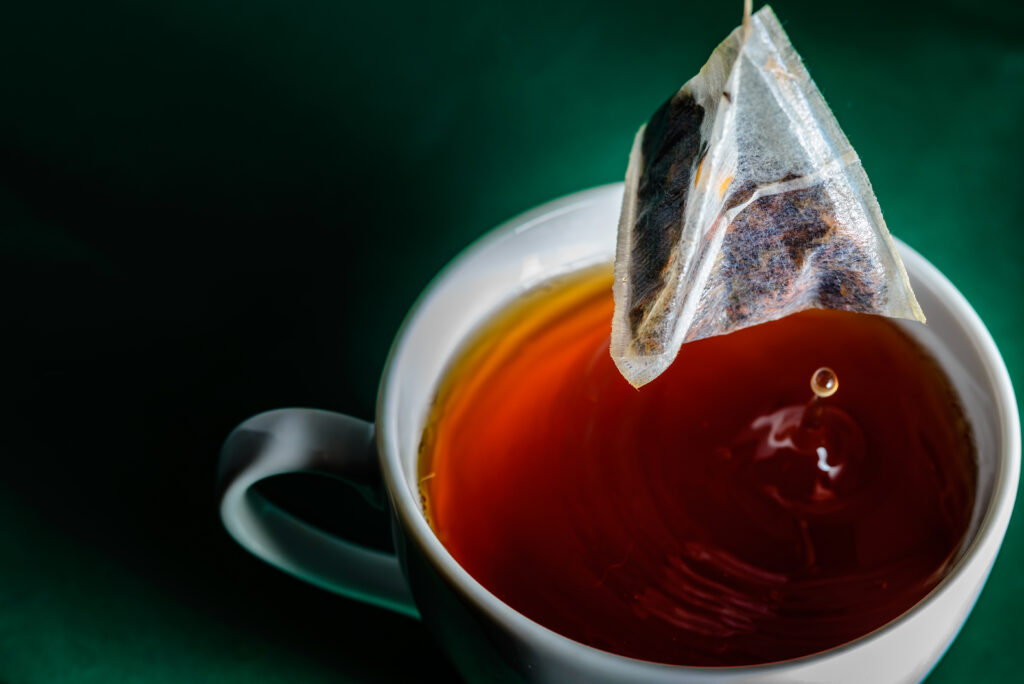 A tea bag. Drinking tea is linked to a wide range of health benefits, but past research indicates that microplastics can be released by tea bags made from or containing plastic, raising health concerns. Companies have created tea bags made from bioplastics and other nonplastic materials, many of which are labeled “biodegradable.” (Image by Pasi Mämmelä via Flickr, CC BY-SA 2.0).