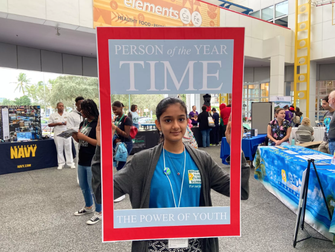 Deerfield Beach High School student, Khushi Desai, held up a Time Person of the Year cover, in honor of climate activist and 2019 person of the year, Greta Thunberg. (Caitie Switalski/WLRN)