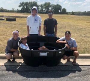 Student athletes pose with a cold water immersion tub donated by the Zach Martin Memorial Foundation. (Courtesy of the Zach Martin Memorial Foundation)