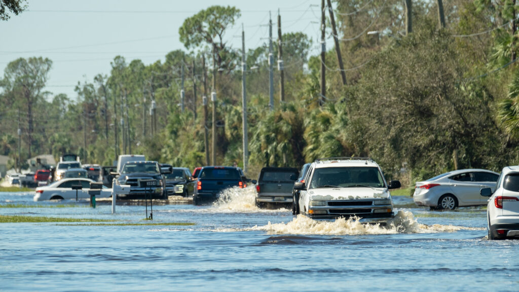 Vehicles pass through flooded streets in Florida. (iStock image)