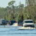 Vehicles pass through flooded streets in Florida. (iStock image)