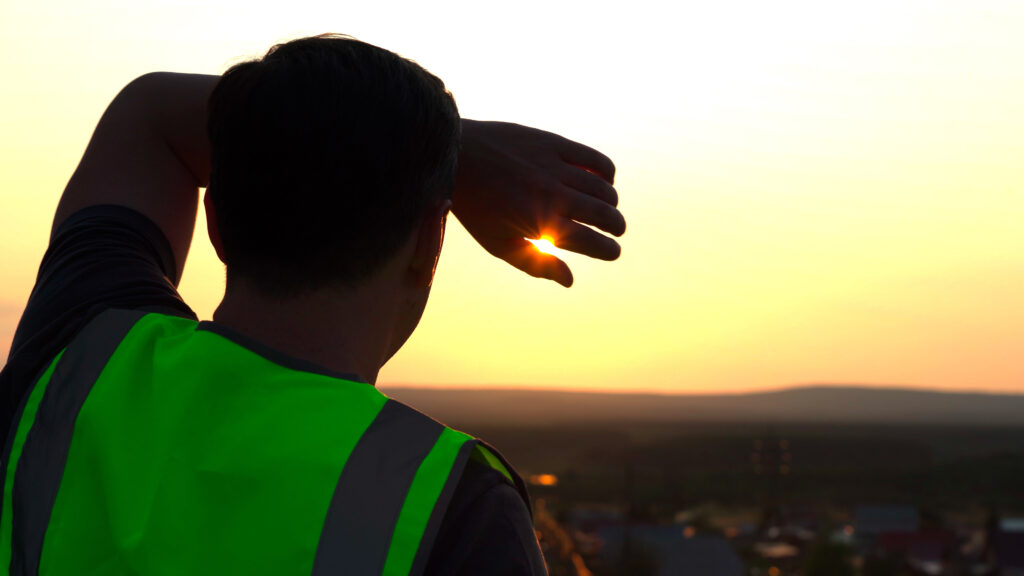 A worker shields himself from the sun (iStock image)