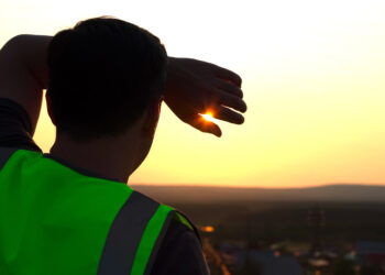 A worker shields himself from the sun (iStock image)