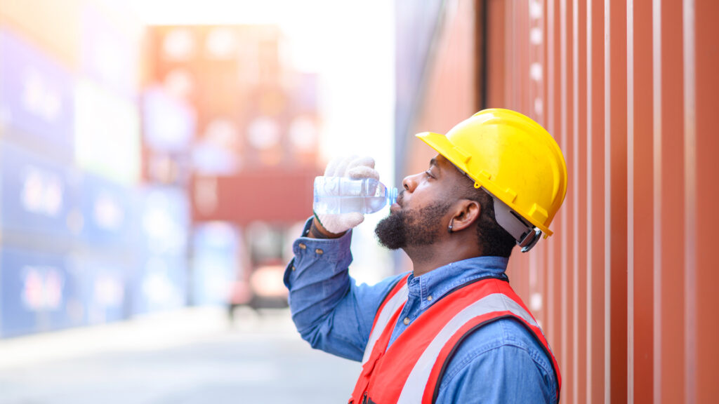 A worker takes a water break in the heat (iStock image)
