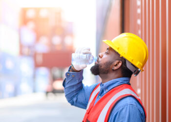 A worker takes a water break in the heat (iStock image)