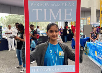 Deerfield Beach High School student, Khushi Desai, held up a Time Person of the Year cover, in honor of climate activist and 2019 person of the year, Greta Thunberg. (Caitie Switalski/WLRN)