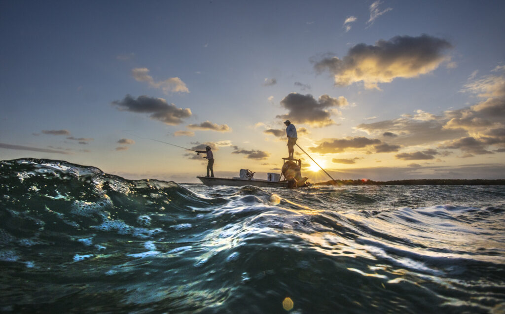 Islamorada, Florida: Florida Keys Fishing Captain Tim Klein directs a fly fishing client to fish off of Islamorada as the sun rises over Florida Bay. (Patrick Farrell for WLRN)