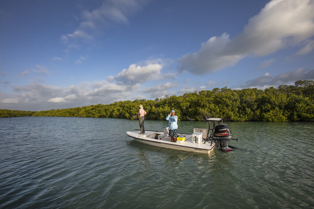 Islamorada, Florida: Florida Keys Fishing Captain Tim Klein uses a small device to check water salinity while looking for fish with a fly fishing client off of Islamorada in Florida Bay. (Patrick Farrell for WLRN)