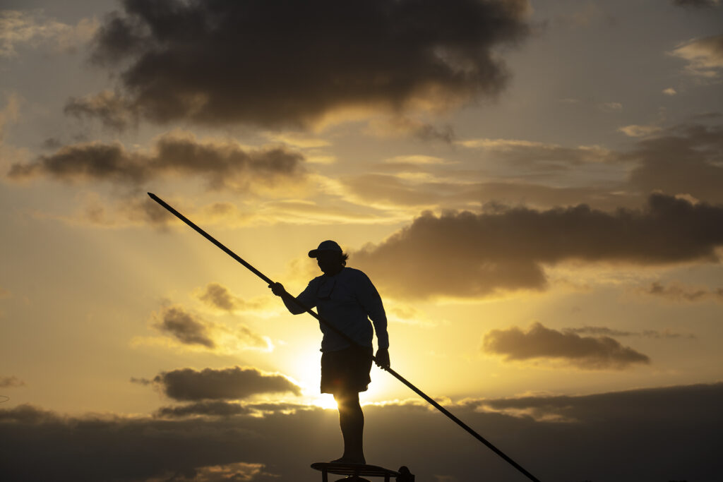 Islamorada, Florida: Florida Keys Fishing Captain Tim Klein directs a fly fishing client to fish off of Islamorada as the sun rises over Florida Bay. (Patrick Farrell for WLRN)