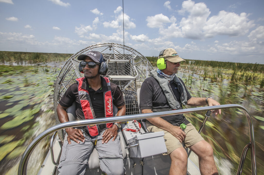 South Bay, Florida: South Florida Water Management District (SFWMD) Senior Scientists Tadese Adeagbo and Eric Crawford head out in their airboat into the Stormwater Treatment Area 1 West to check out their work in vegetation management. (Patrick Farrell for WLRN)
