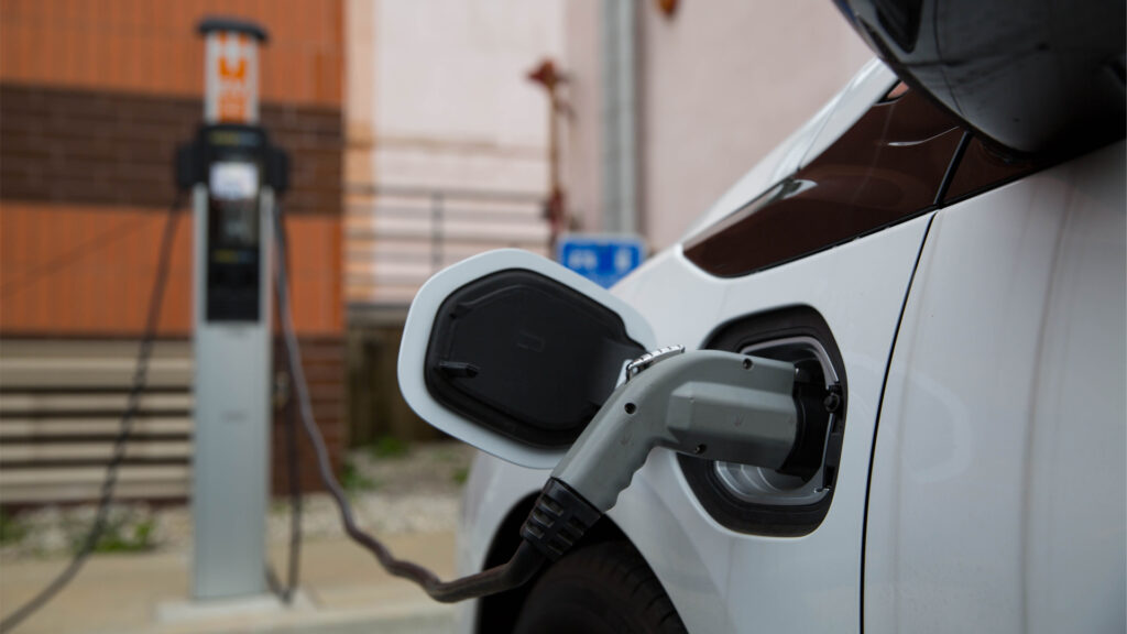 An electric vehicle at a public charging station (iStock image)