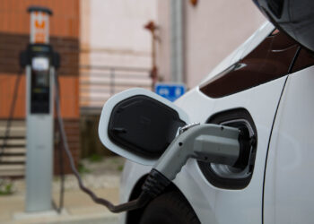 An electric vehicle at a public charging station (iStock image)
