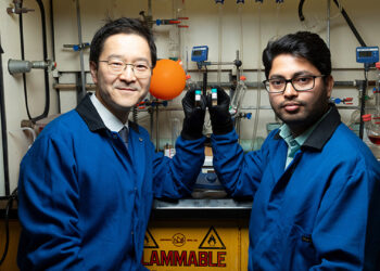 From left, Associate Professor Hoyong Chung and postdoctoral researcher Arijit Ghorai display the two phases of their degradable polymer at the Dittmer Chemistry Lab at Florida State University. (Scott Holstein/FAMU-FSU College of Engineering)