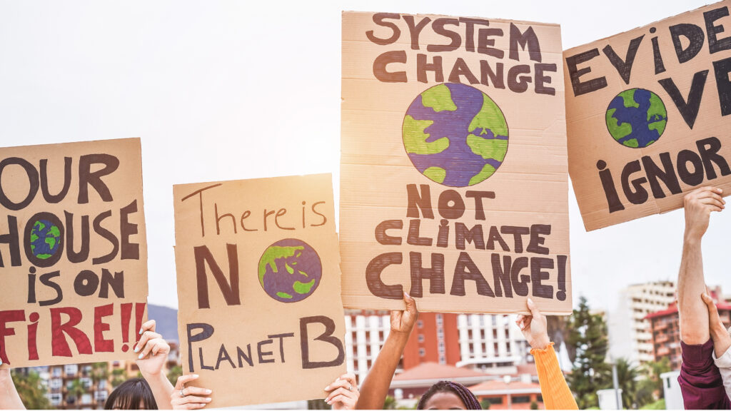 Demonstrators hold signs about climate change (iStock image)