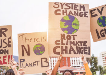 Demonstrators hold signs about climate change (iStock image)