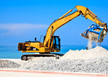 Heavy equipment filters rock from sand as part of a beach renourishment project on Anna Maria Island. (iStock image)