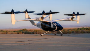 A Joby Aviation experimental electronic vertical take-off and landing aircraft is parked at taxiway following a ground test at Edwards Air Force Base in California in 2023 (Harlan Huntington, Public domain, via Wikimedia Commons)