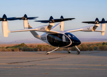 A Joby Aviation experimental electronic vertical take-off and landing aircraft is parked at taxiway following a ground test at Edwards Air Force Base in California in 2023 (Harlan Huntington, Public domain, via Wikimedia Commons)