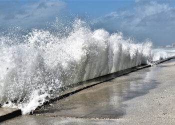 A wave crashes against a seawall in St. Pete Beach. (iStock image)