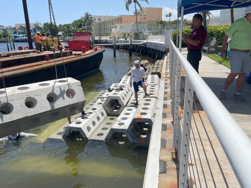 University of Miami Associate Professor of Engineering Landolf Rhode-Barbarigos waits to help position another unit of SEAHIVE, as part of the largest installation of the units yet happening at Wahoo Bay. (Photo: Janette Neuwahl Tannen/University of Miami)