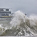 A wave crashing against a seawall on Tampa Bay during a tropical storm with the St Pete Pier in the background. (iStock image)