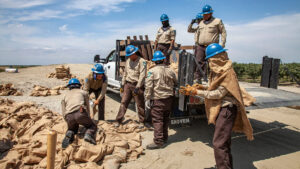 Members of the California Conservation Corps, which has open positions with the American Climate Corps, build a levee at California's Tulare Lake in 2023. (Citizen of the Planet/UCG/Universal Images Group/Getty Images via Grist)