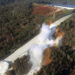 An aerial photo of the damaged spillway of the Oroville Dam and an eroded hillside in 2017. (William Croyle, California Department of Water Resources, Public domain, via Wikimedia Commons)