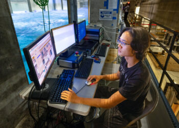 Peisen Tan conducts laboratory experiments with Category 4 hurricane-force winds blown over mechanically generated waves. (Photo: Joshua Prezant/University of Miami)