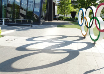 Sun shines through the Olympic Rings in Tokyo, site of the 2020 Summer Olympics. (RuinDig/Yuki Uchida, CC BY 4.0, via Wikimedia Commons)