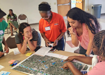 Community members in East Tampa identifying neighborhood amenities and walking distances during the East Tampa community engagement workshop for the heat vulnerability study. (Photo courtesy of USF)