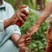A mother sprays her child with insect repellent. (iStock image)