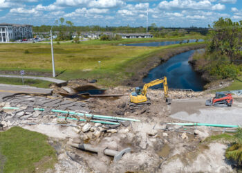 A road and bridge damaged by flooding are reconstructed in Florida (iStock image)