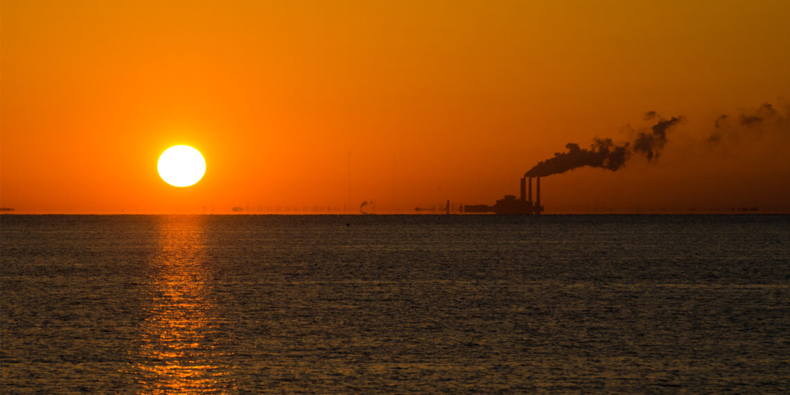 The sun rises as a power plant emits smoke near St. Petersburg (iStock image)