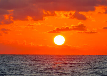 The sun rises over the ocean (iStock image)