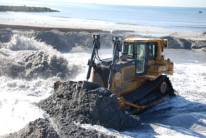 A bulldozer moves sand pumped onto Rockaway Beach as part of a renourishment project there to repair damage to the beach caused by winter storms. (Ken Wells/U.S. Army Corps of Engineers New York, CC BY 2.0, via flickr)