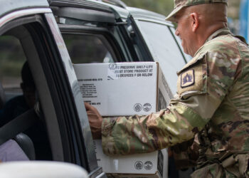 Florida Army National Guard Staff Sgt. Martin Martinez distributes food in Bradenton to assist the local community Oct. 11 following Hurricane Milton. (U.S. Army photo by Sgt. Marc Morgenstern, via Defense Visual Information Distribution Service)