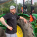 Jeremy Ford stands near a tractor with automation. (Ayurella Horn-Muller/Grist)