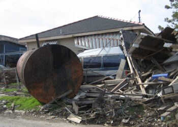 A storage tank deposited on residential street by flood waters in New Orleans after Hurricane Katrina. (Infrogmation, CC BY 2.5, via Wikimedia Commons)