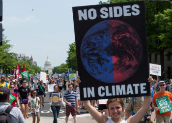 A demonstrator holds a sign at the 2017 D.C. Climate March (Mark Dixon, CC BY 2.0, via flickr)