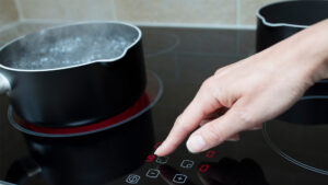 The temperature is adjusted on an induction stove (iStock image)