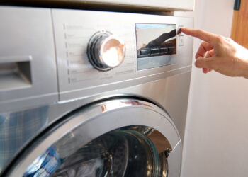 A washing machine is adjusted (iStock image)