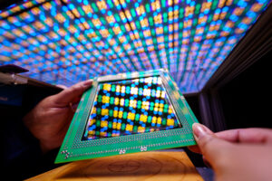 A scientist at Sandia National Laboratories’ Photovoltaic System Evaluation Laboratory, in Albuquerque, places a perovskite module in a solar simulator of LED lights to simulate the sun with a flash of light. (Craig Fritz/Flickr)