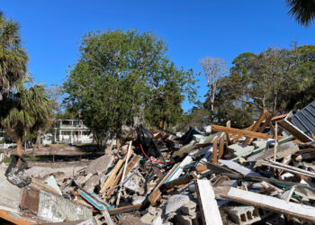 Large piles of debris remained in Cedar Key, some two months after Hurricane Helene hit. (Credit: Amy Green/Inside Climate News)