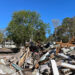 Large piles of debris remained in Cedar Key, some two months after Hurricane Helene hit. (Credit: Amy Green/Inside Climate News)