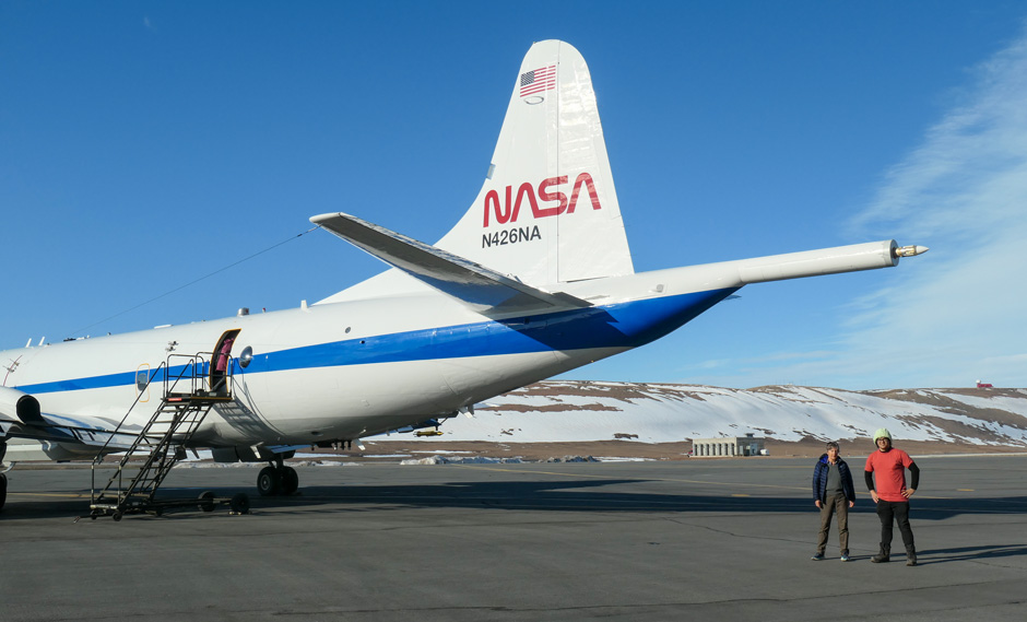 Rosenstiel School researchers Paquita Zuidema and Michael Perez stand near the tail section of the NASA aircraft on which they flew to conduct experiments on ice melt in the Arctic. (Photo courtesy of Paquita Zuidema)