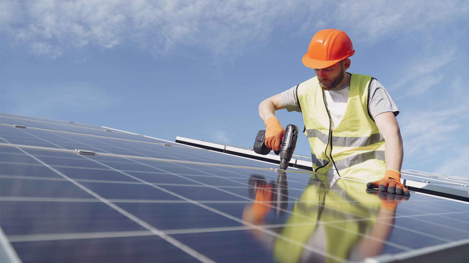 A worker installs solar panels (iStock image)