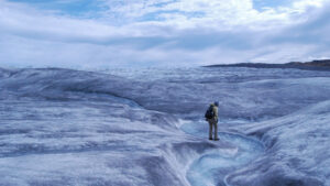 Persistent melt lifted the snow cover from a low-lying area of Greenland's ice sheet, revealing a rough terrain crossed by meltwater streams. (NASA GSFC, Public domain, via Wikimedia Commons)