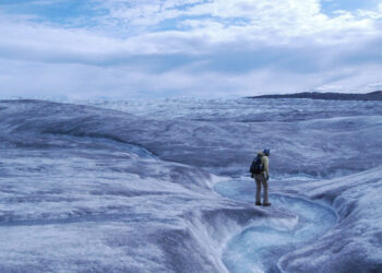 Persistent melt lifted the snow cover from a low-lying area of Greenland's ice sheet, revealing a rough terrain crossed by meltwater streams. (NASA GSFC, Public domain, via Wikimedia Commons)
